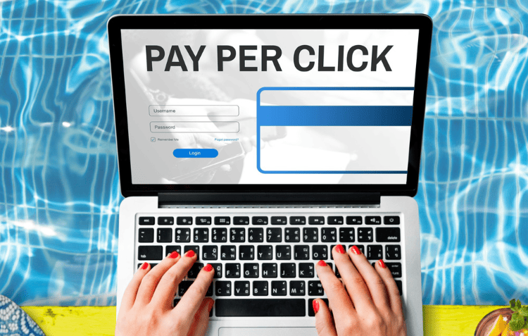 A laptop showing a “PAY PER CLICK” webpage with a login form, promoting PPC advertising guide.