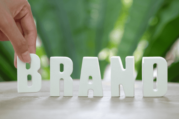 The word “BRAND” in white letters, promoting brand building strategies.