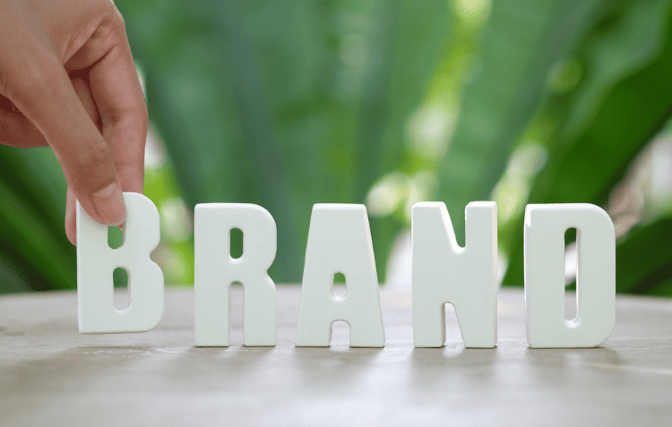 The word “BRAND” in white letters, promoting brand building strategies.