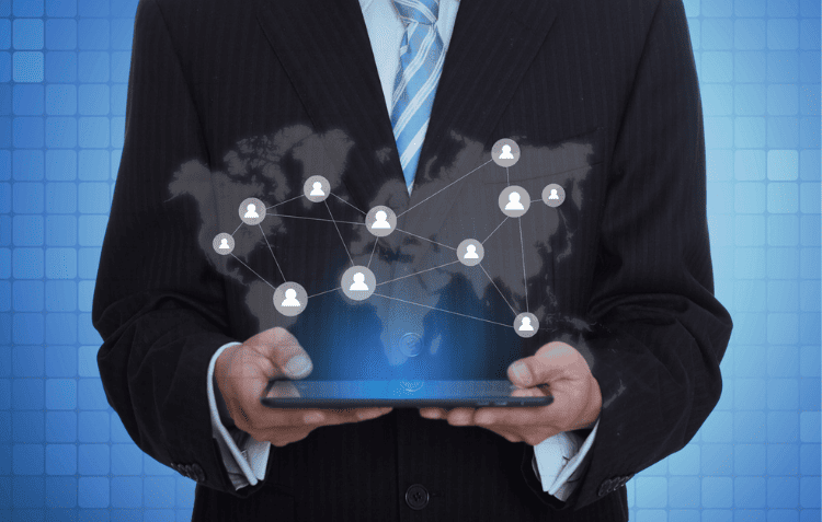 Businessman holding tablet with network map