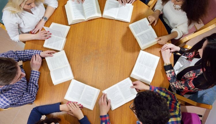 Group of teens in a book club reading together