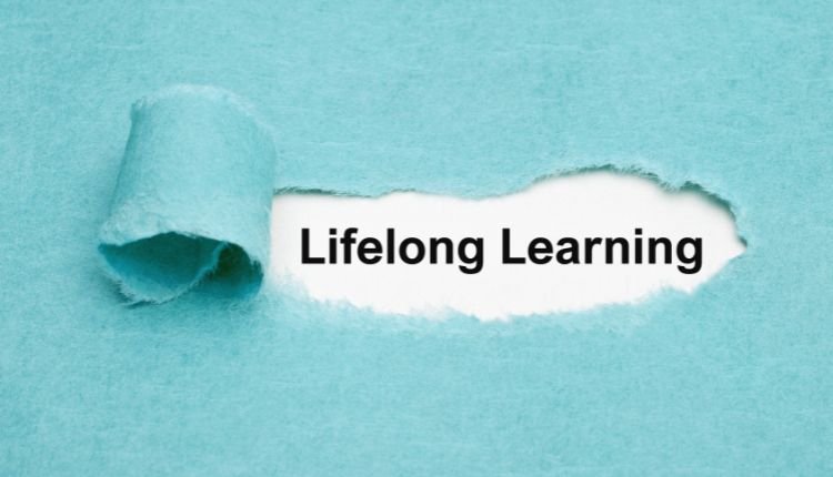 Lifelong learning text on torn blue paper