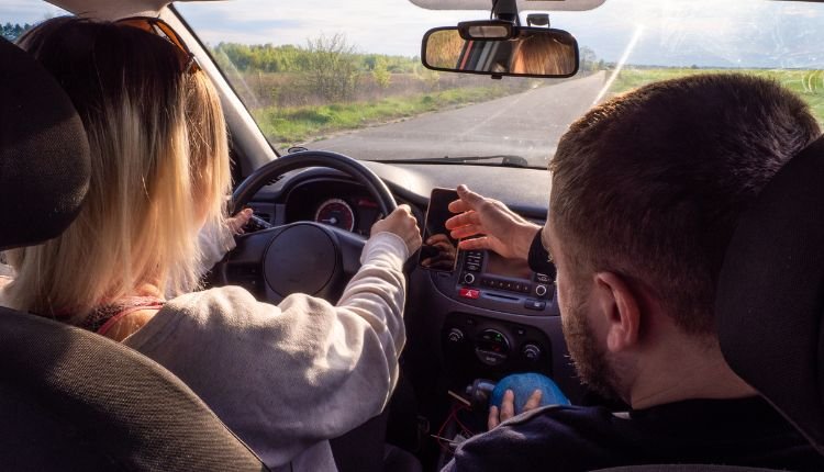 Instructor guiding a student during a driving lesson