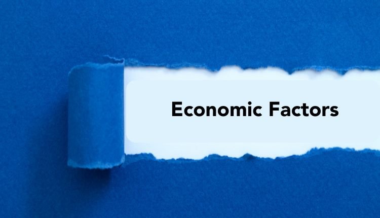 Blue torn paper revealing text "Economic Factors"