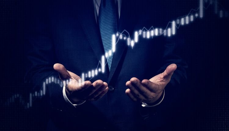 Businessman presenting a glowing stock market graph.