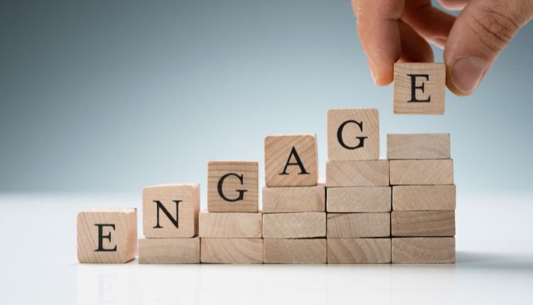 Stacked wooden blocks spelling "ENGAGE" for customer retention.